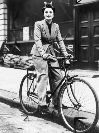 Girl in Trousers rides a bike